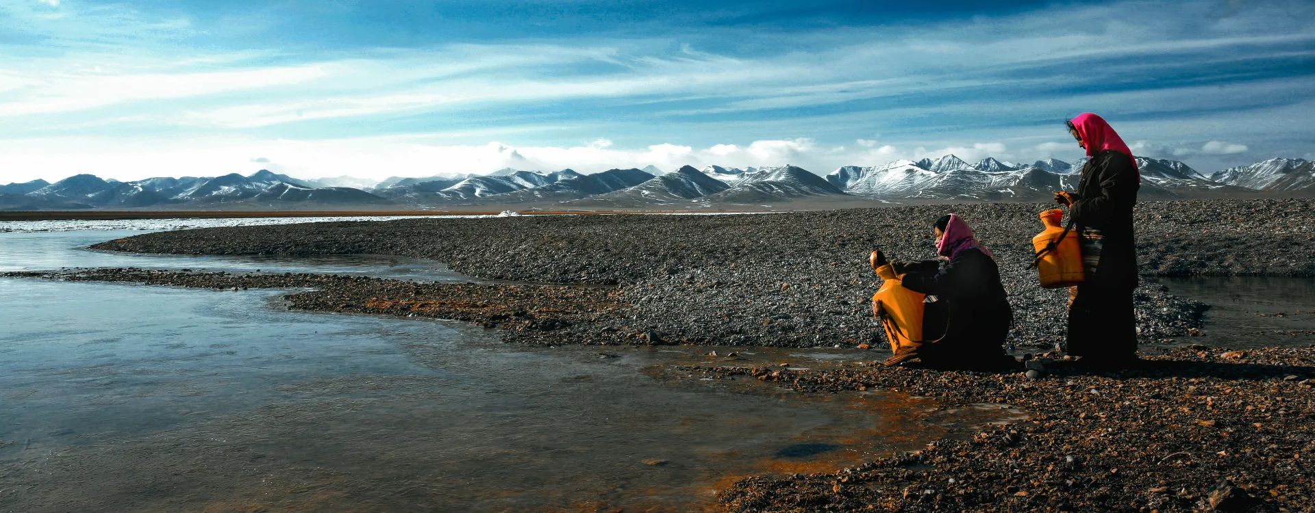 Women gathering water at a lake, luxury holidays to Tibet