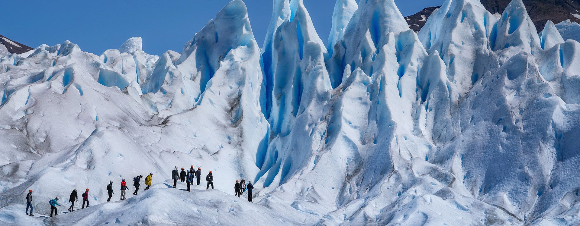 Tourists trekking on Perito Moreno Glacier in Los Glaciares National Park near El Calafate in Argentina, Patagonia, South America.