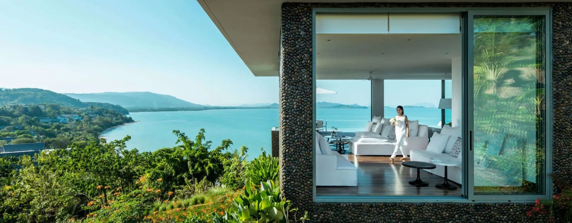 Como Thailand hotel with lush greenery and ocean in the background
