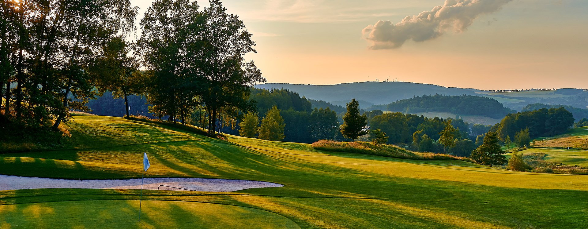 Sunset and golf course with flag, Europe. Czech Republic.