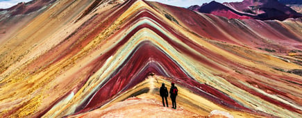 Tourists couple stand and look afar at Rainbow Mountains, Cusco, Peru