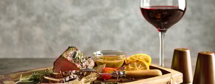 Sliced tasty steak on wooden board