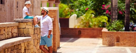 father and son having fun on cute tropical street
