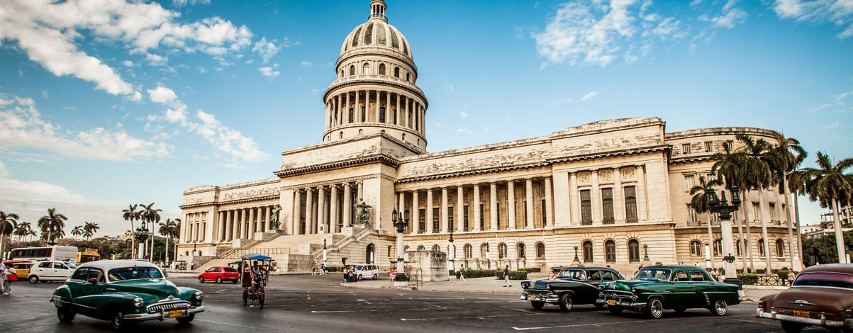 Old car rides in front of the Capitol in Havana