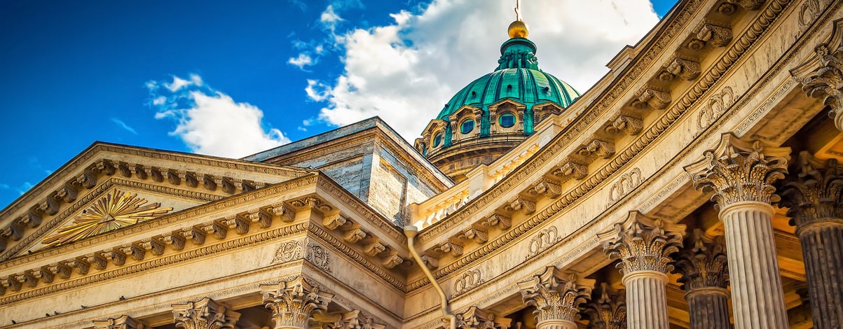 Colonnade and blue dome with golden cross on Kazansky cathedral in Saint Petersburg, Russia.