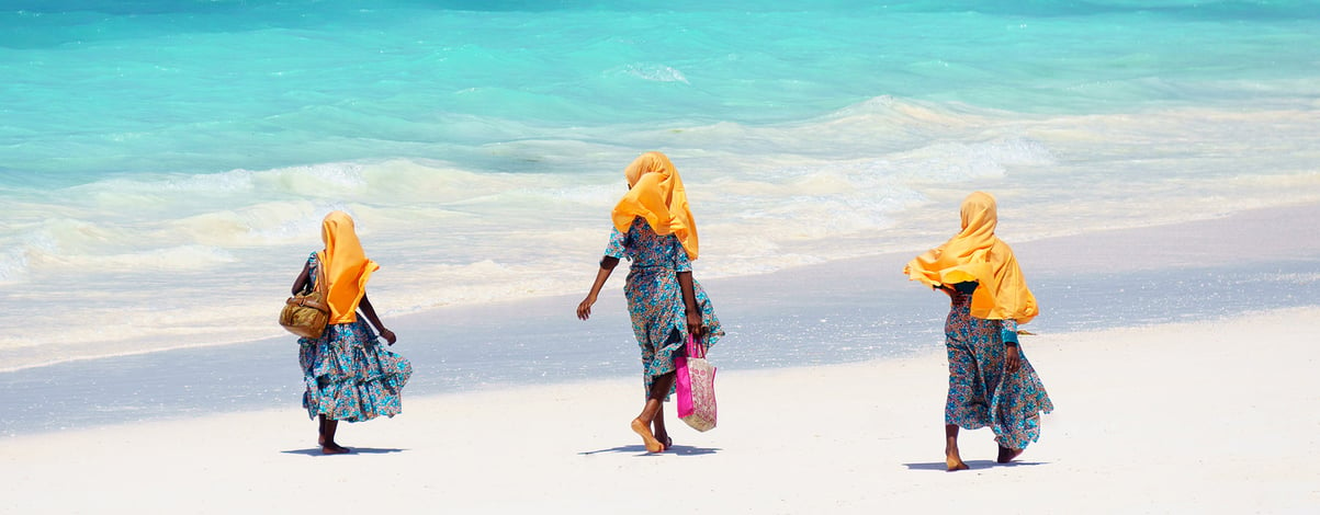 Kids walking on the beach in Zanzibar Tanzania