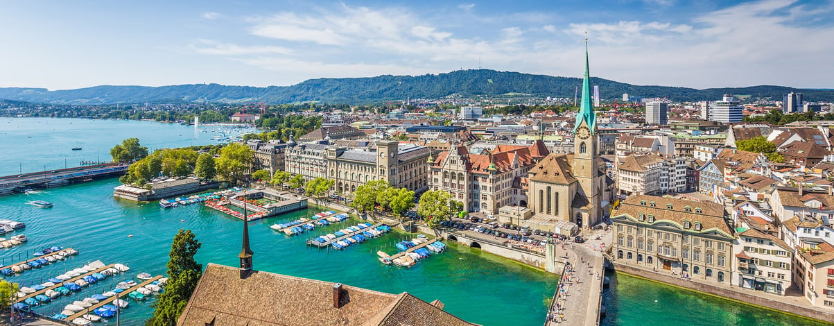 Zurich city center with famous Fraumunster Church and river Limmat at Lake Zurich from Grossmunster on a sunny day with blue sky, Canton of Zurich, Switzerland