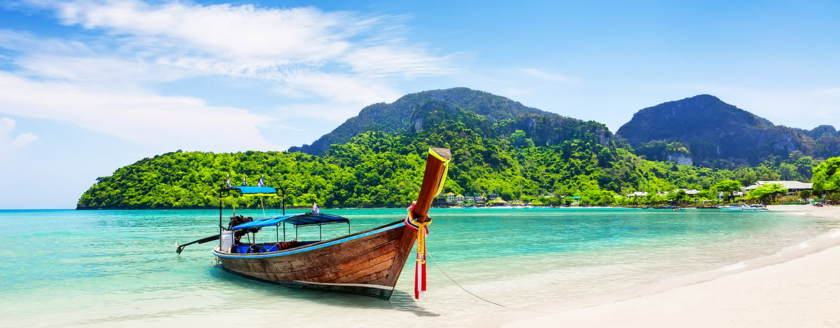 Thai traditional wooden longtail boat, beach at Koh Phi Phi island in Krabi, Thailand