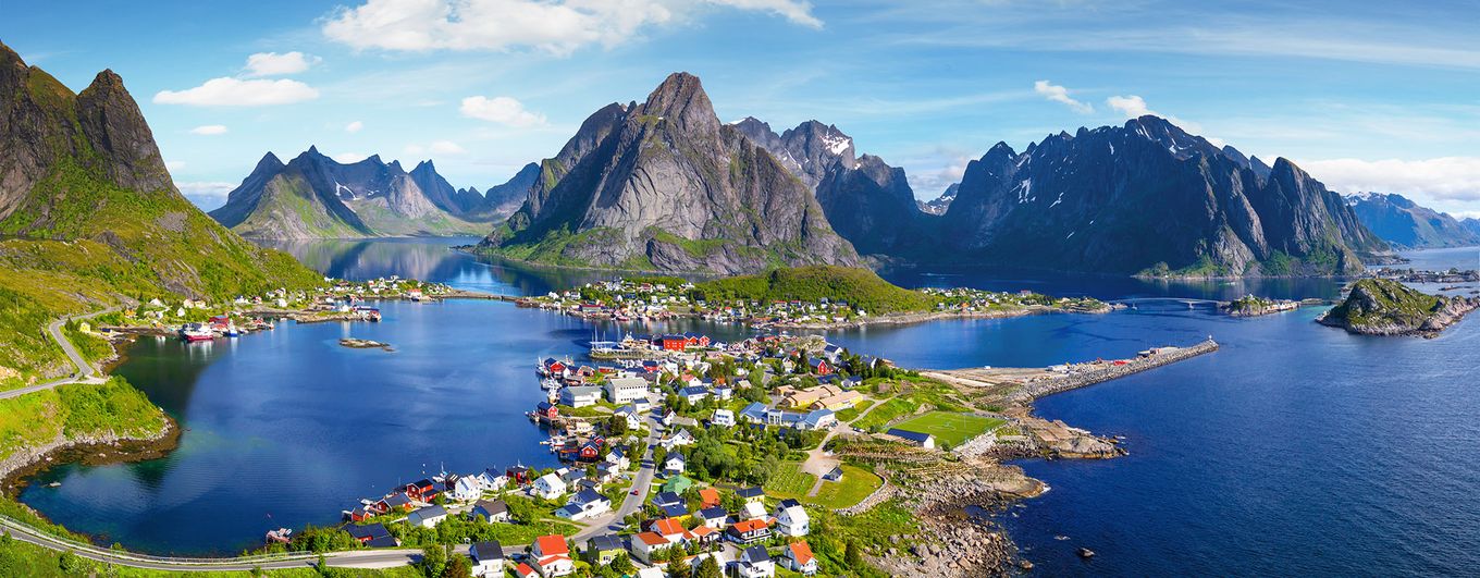 Reine, Lofoten, Norway. The village of Reine under a sunny, blue sky, with the typical rorbu houses. View from the top