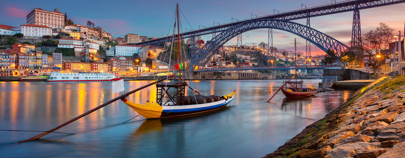 Porto, Portugal. Cityscape image of Porto, Portugal with reflection of the city in the Douro River and the Luis I Bridge during sunrise