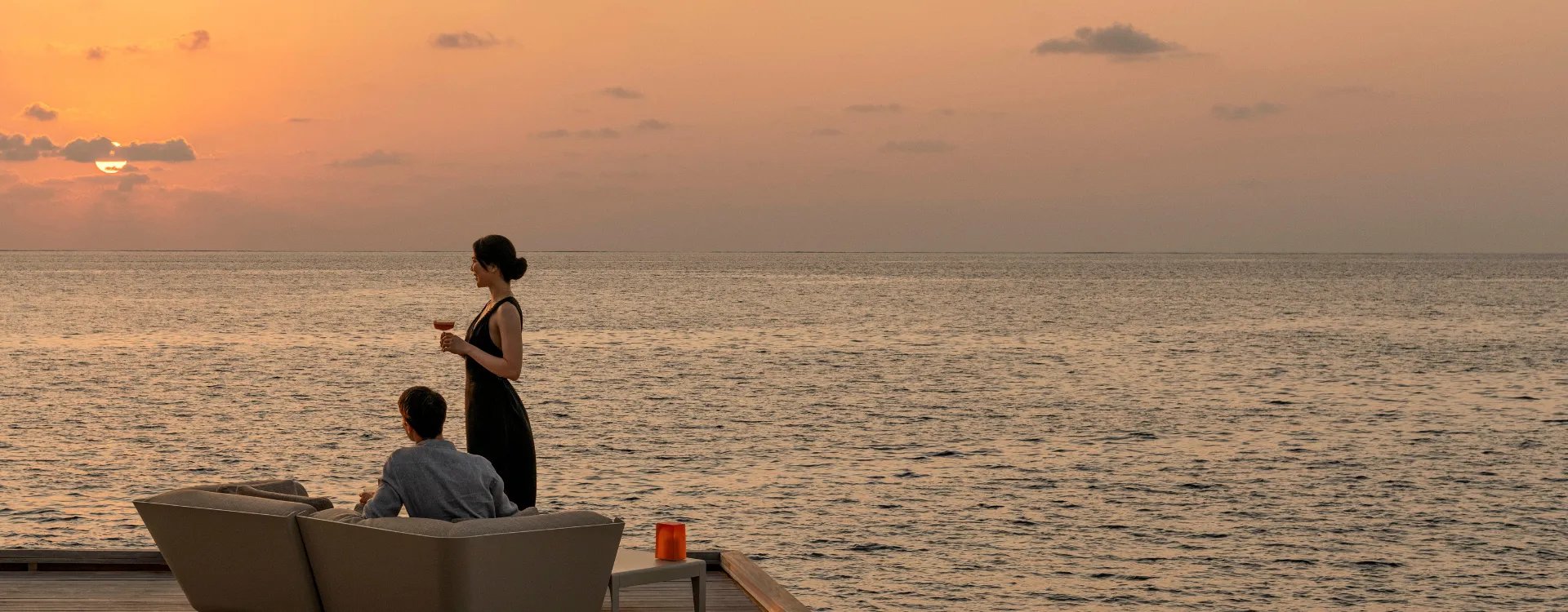 Asian couple enjoying sunset in the Maldives