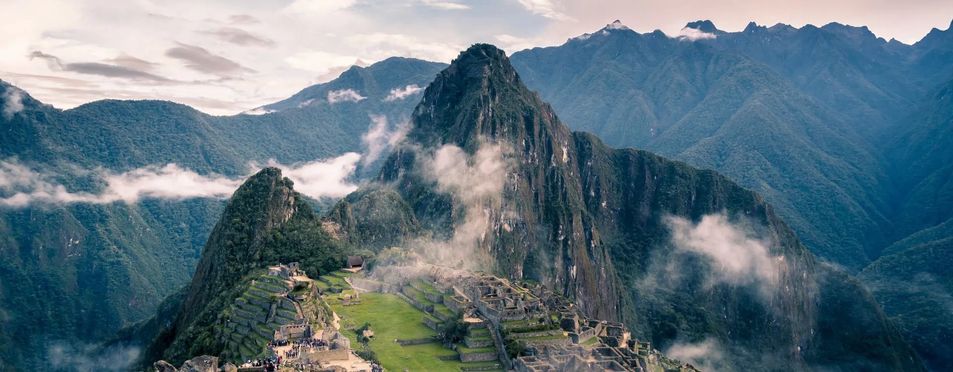 A view of Machu Picchu in Peru with swirling clouds