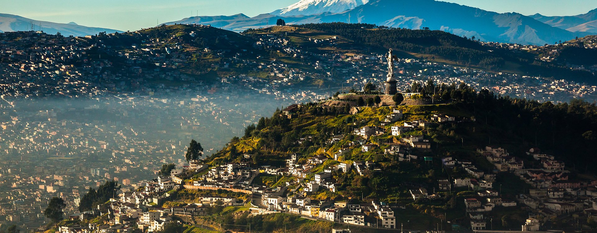 View of El Panecillo in the center of Quito with the Cotopaxi in the background