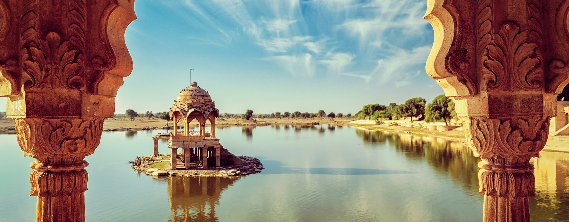 Indian landmark Gadi Sagar - artificial lake view through arch. Jaisalmer, Rajasthan, India