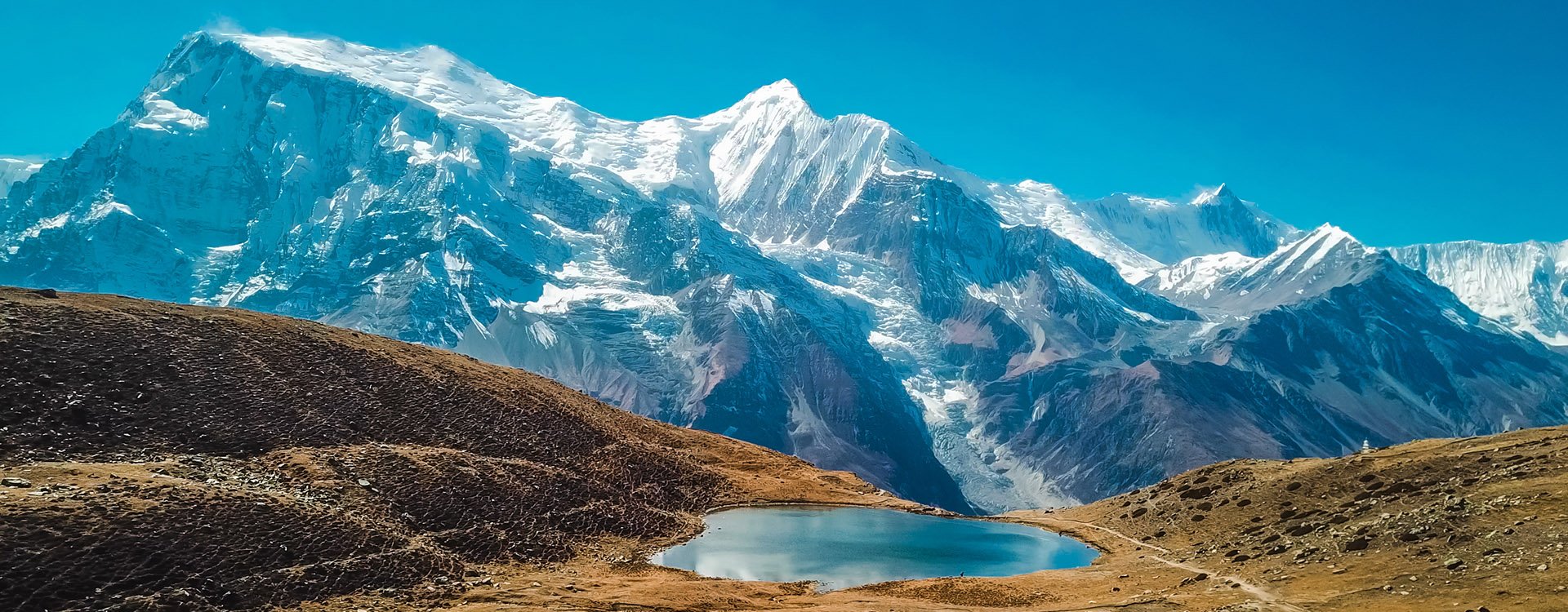 Ice lake, as part of the Annapurna Circuit Trek detour, Himalayas, Nepal. Annapurna chain in the back, covered with snow