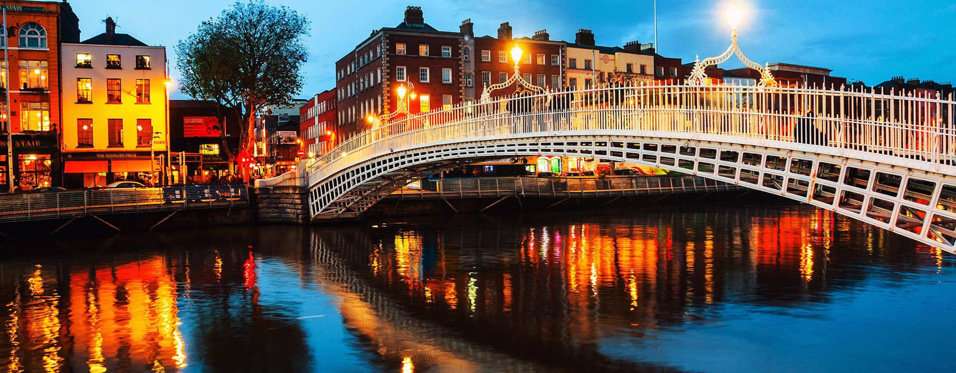 Dublin, Ireland. Night view of famous illuminated Ha Penny Bridge in Dublin, Ireland