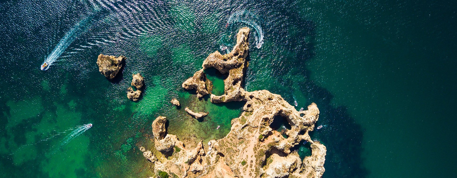 Aerial of Scenic Ponta da Piedade of Lagos, Portugal. Rugged seaside cliffs and aqua ocean waters in the Algarve region of Portugal