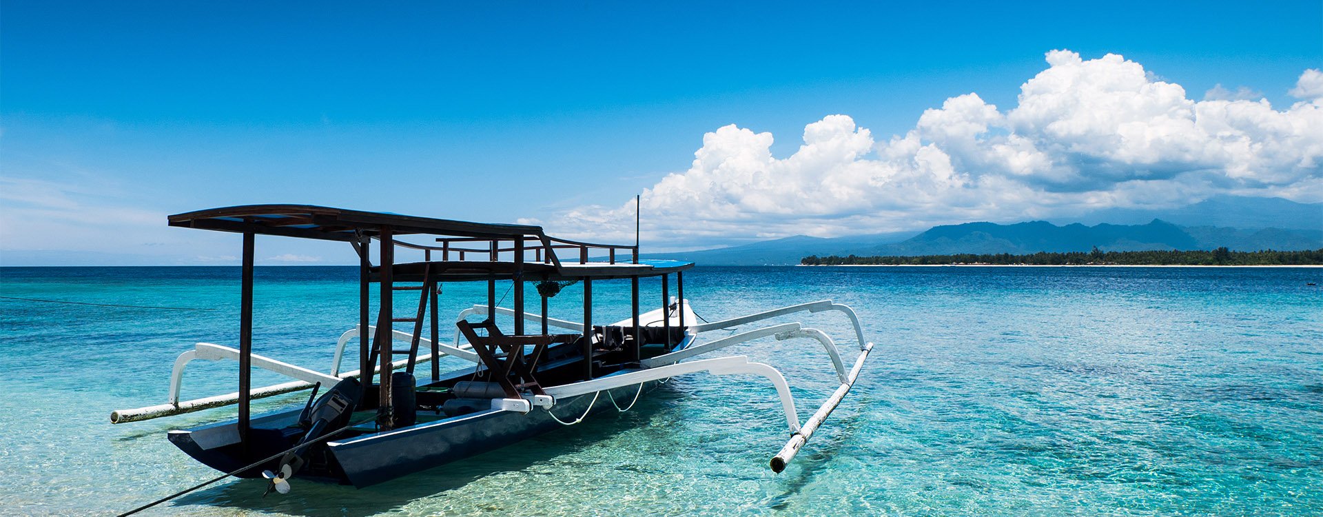 Boats moored on clear ocean waters at Gili Meno of Lombok, Indonesia, Asia