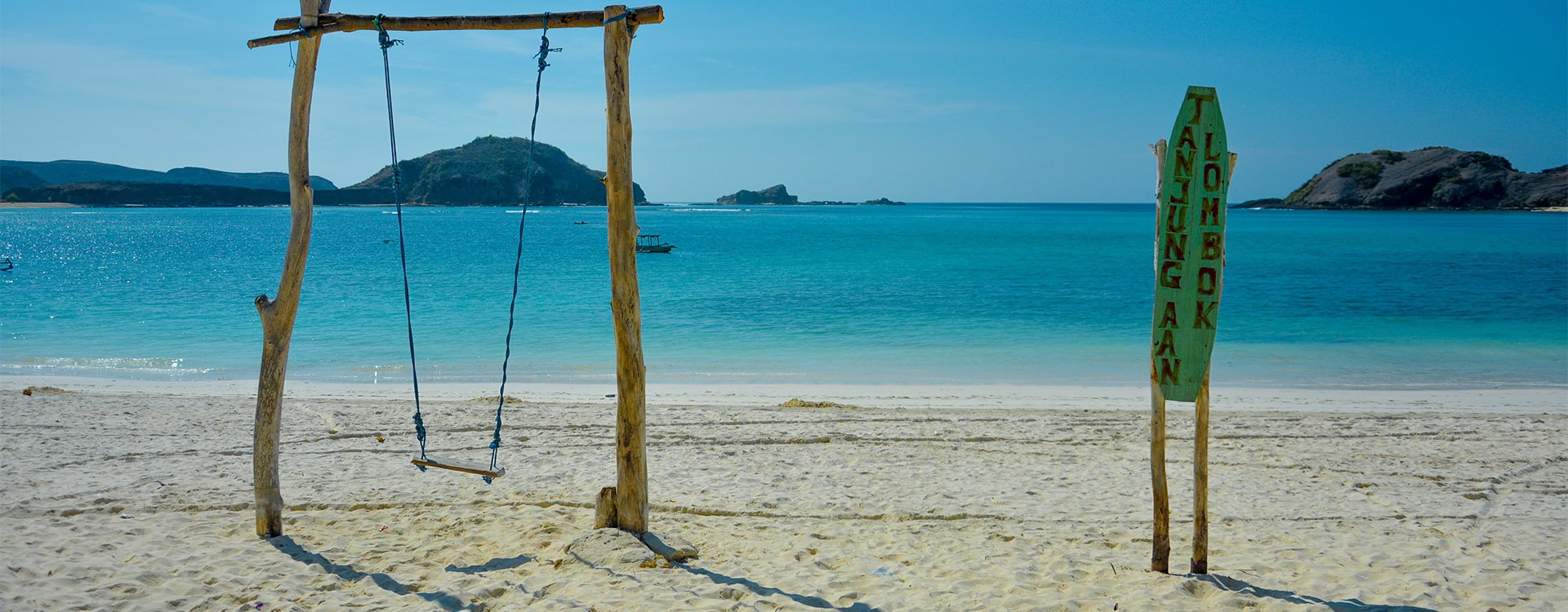 Wooden swing along the beauty of Tanjung Aan Beach, Lombok Island, Indonesia