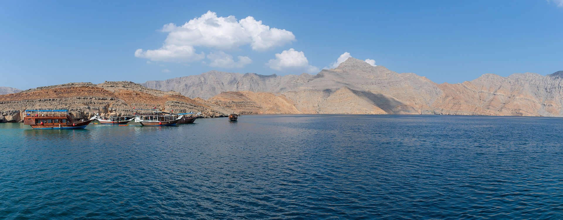 Panorama View from Dhow Boat to spectacular rocky mountains of northern Oman