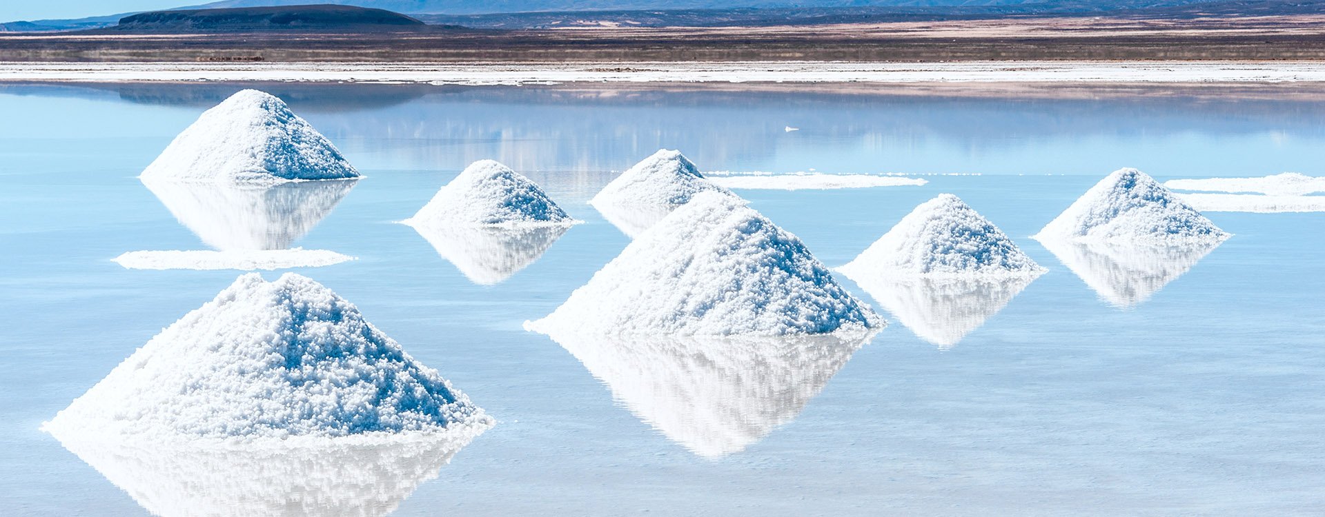 Salt lake and salt piles in salt flats Uyuni in Bolivia