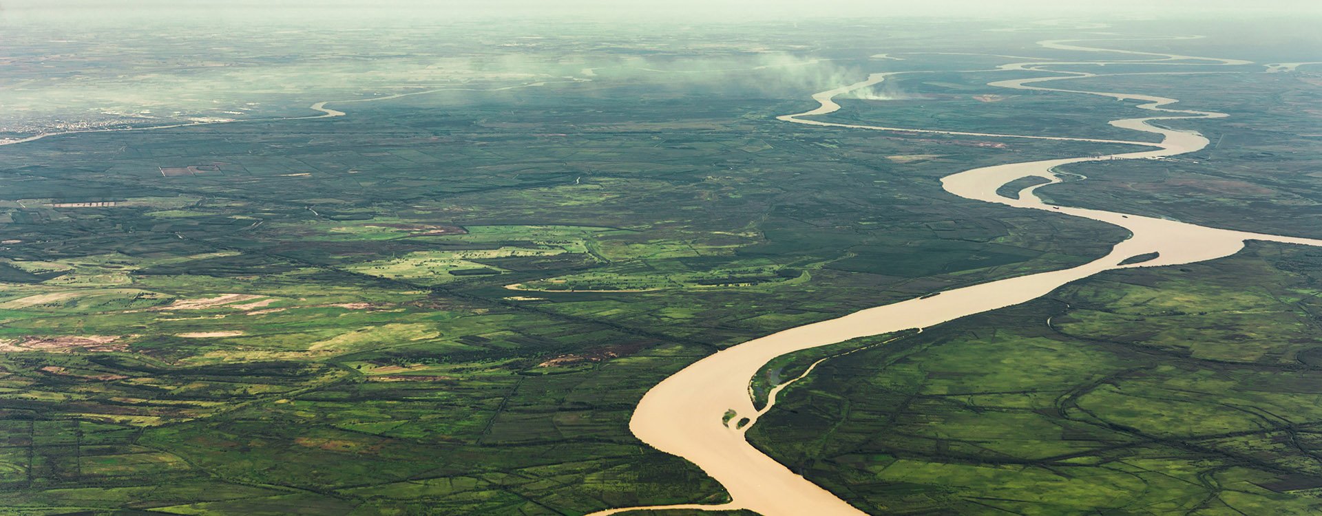 Landscape aerial view of colorful Amazon rivers, forest with trees, jungle, and fields