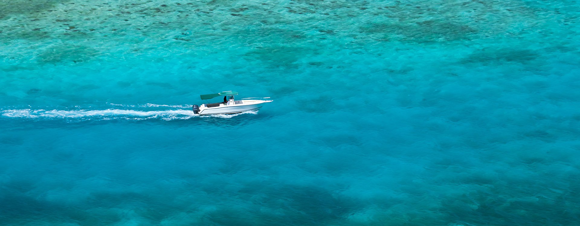 Small power boat on turquoise Caribbean Sea of The british virgin islands