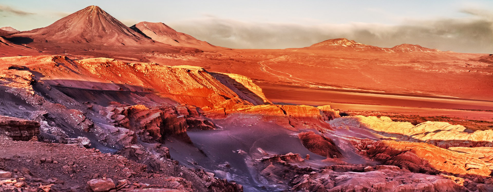 Sunset in front of the volcano and the salt desert