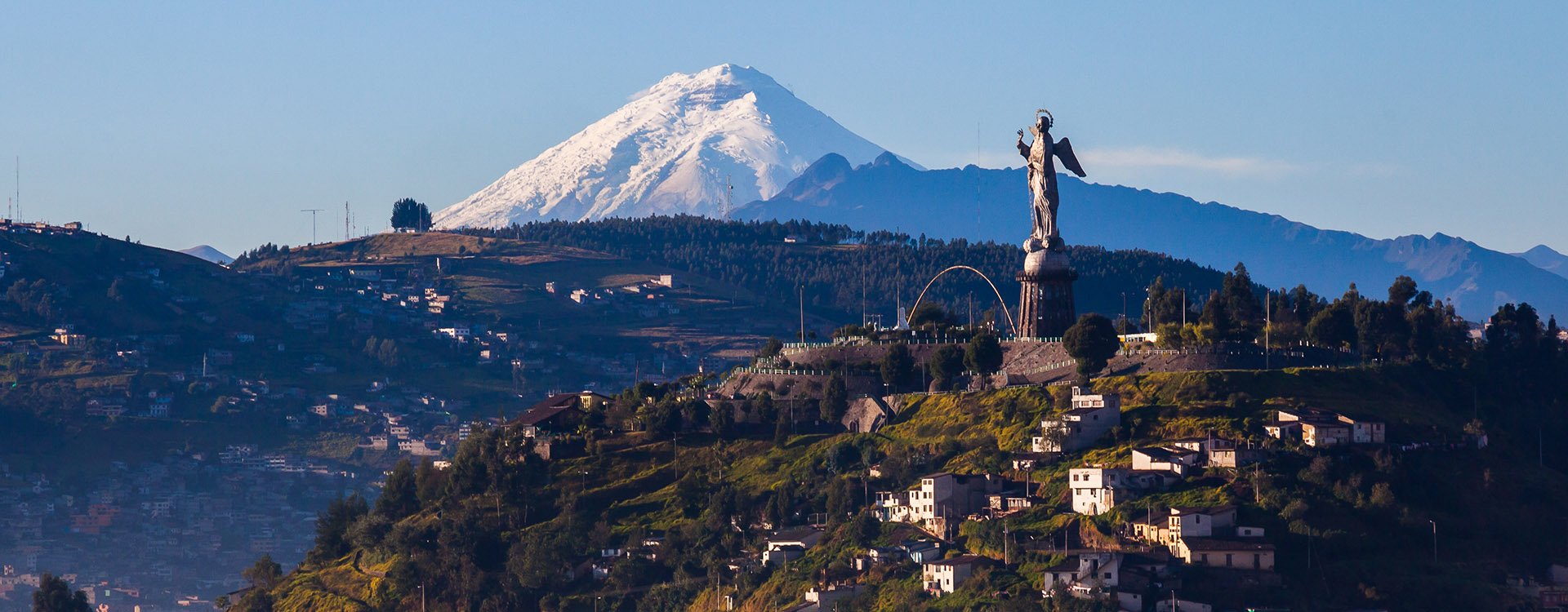 View of El Panecillo in the center of Quito with the Cotopaxi in the background