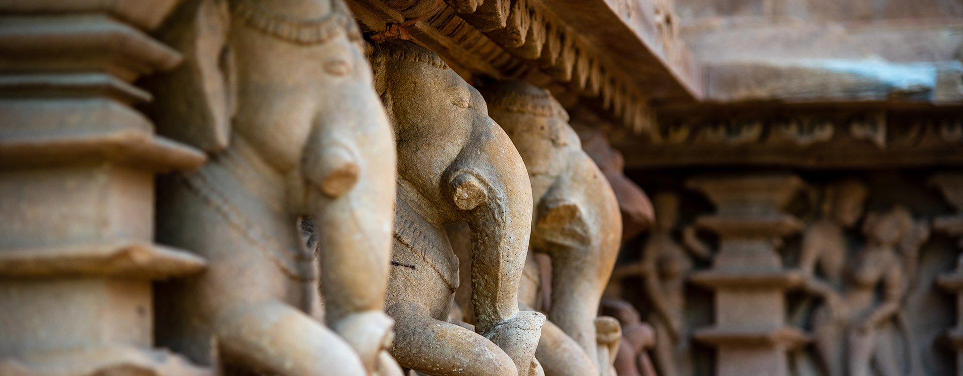 Ornated sculptures banded around the temple perimeter of Khajuraho Temple
