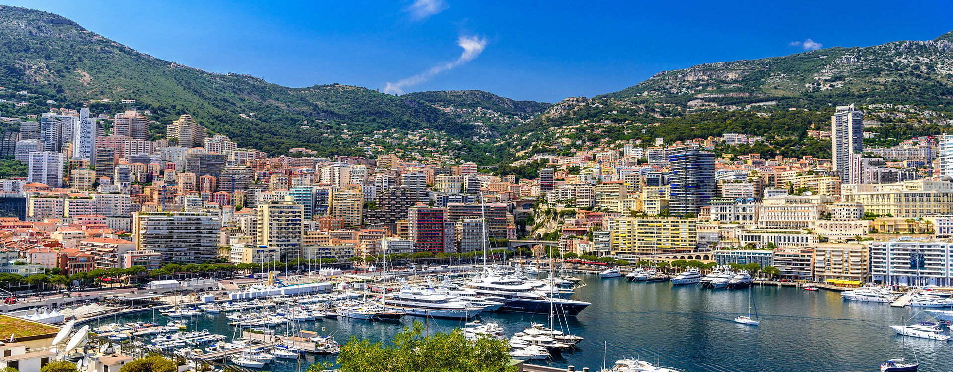 Yachts in bay near houses and hotels, La Condamine, Monte-Carlo, Monaco, Cote d'Azur, French Riviera.