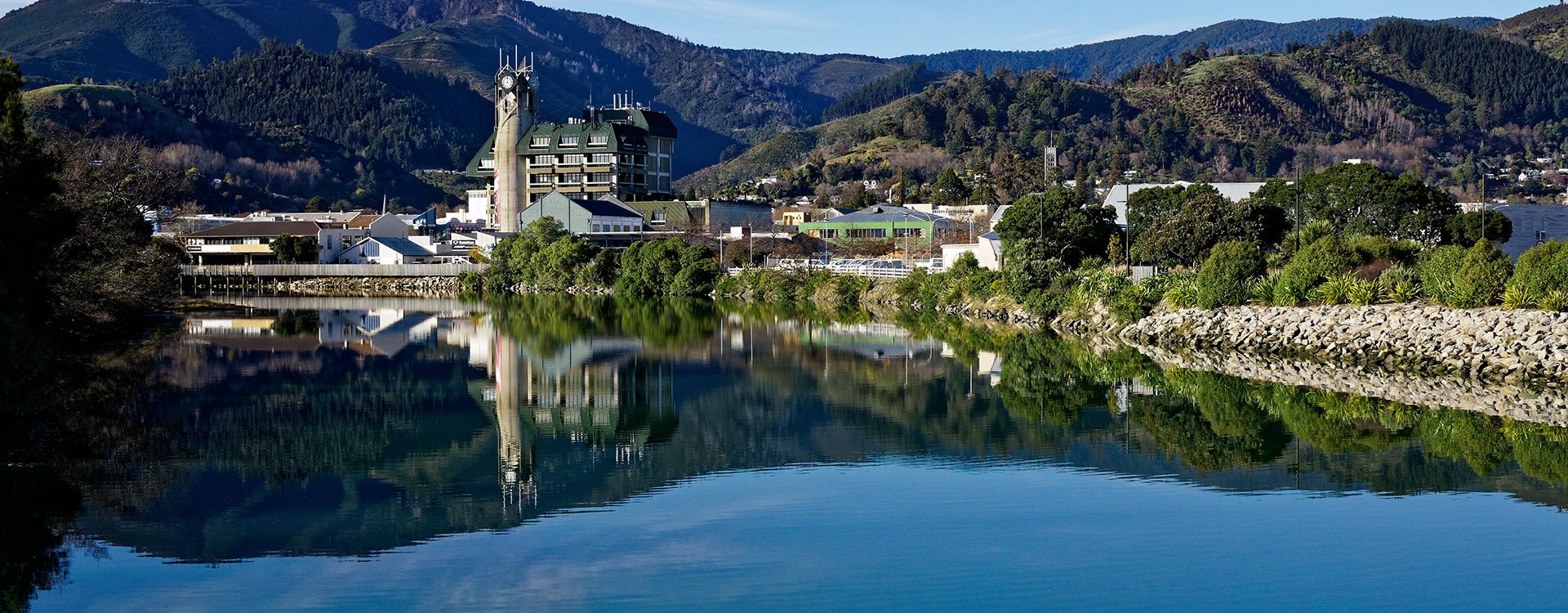 Panorama of Nelson reflected in the Maitai river, New Zealand