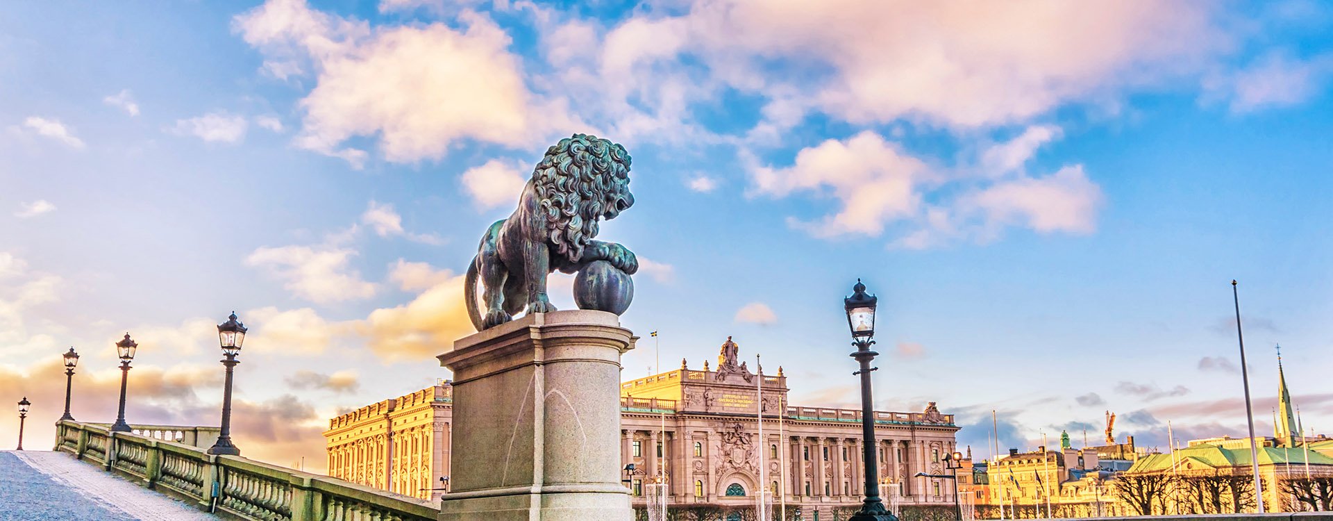 Sculptures of lions near the main staircase of the Royal Palace of Stockholm and a view of the Parliament Building (Riksdagshuset) in Stockholm, the capital of Sweden