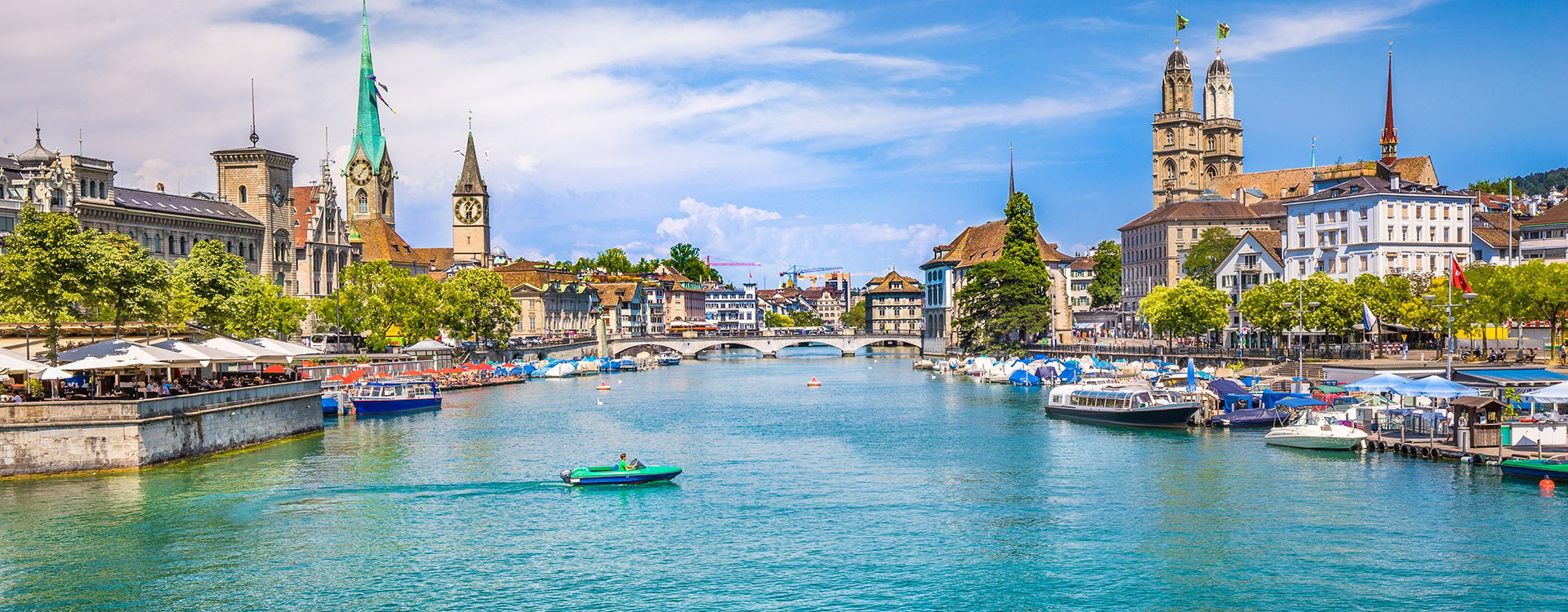 Historic Zurich city center with famous Fraumunster, Grossmunster and St. Peter and river Limmat at Lake Zurich on a sunny day with clouds in summer, Canton of Zurich, Switzerland