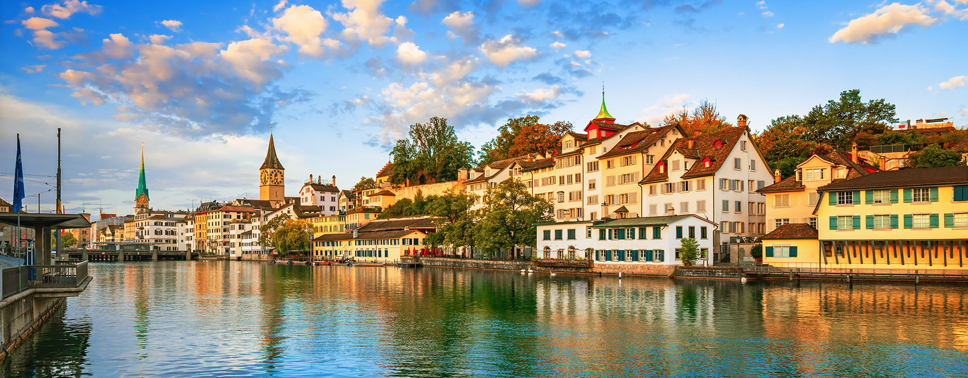 Historic Zurich city center with famous Fraumunster and Grossmunster Churches and river Limmat at Lake Zurich on a sunny day with clouds in summer, Canton of Zurich, Switzerland