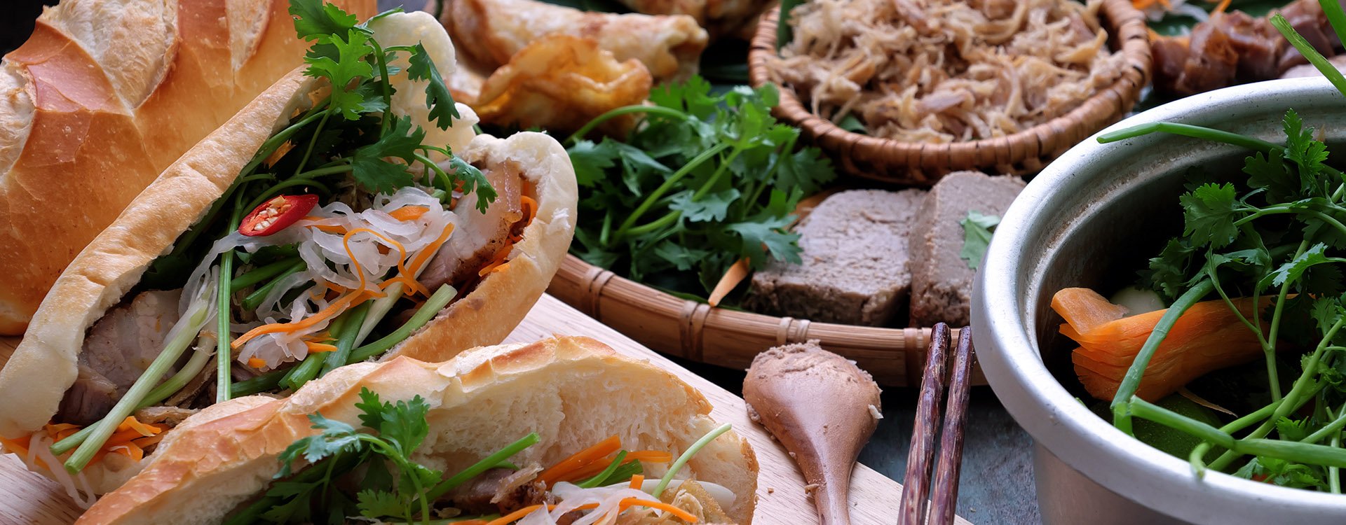Famous Vietnamese food is banh mi thit bread stuffed with raw ingredients: pork and vegetables