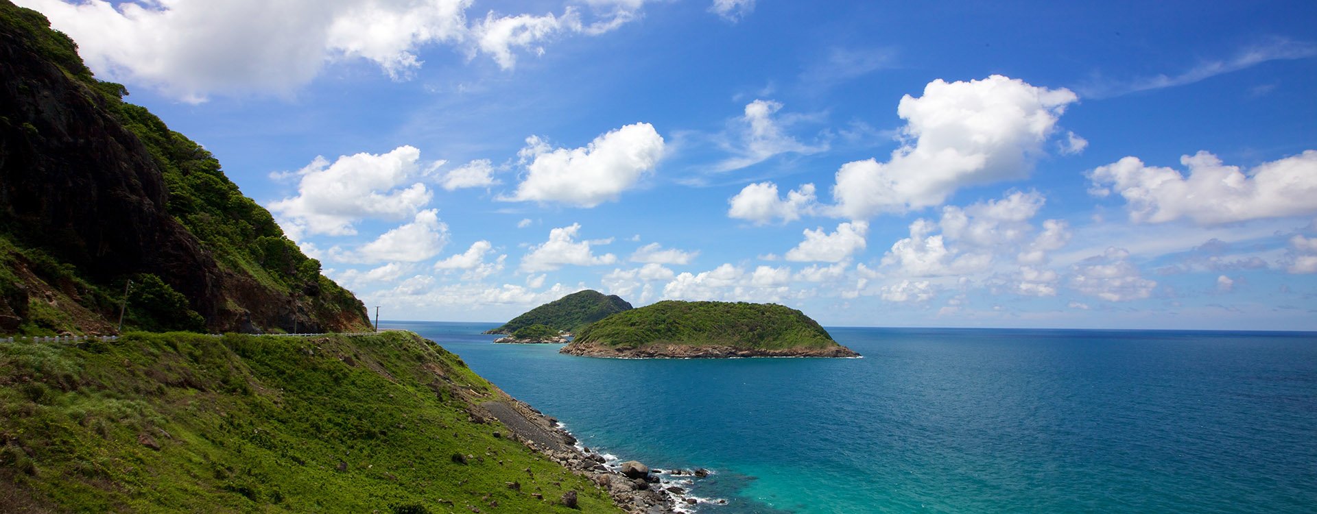 Scenic drive along coast of Con Dao Island, Vietnam blu clear ocean and a bright sunny day
