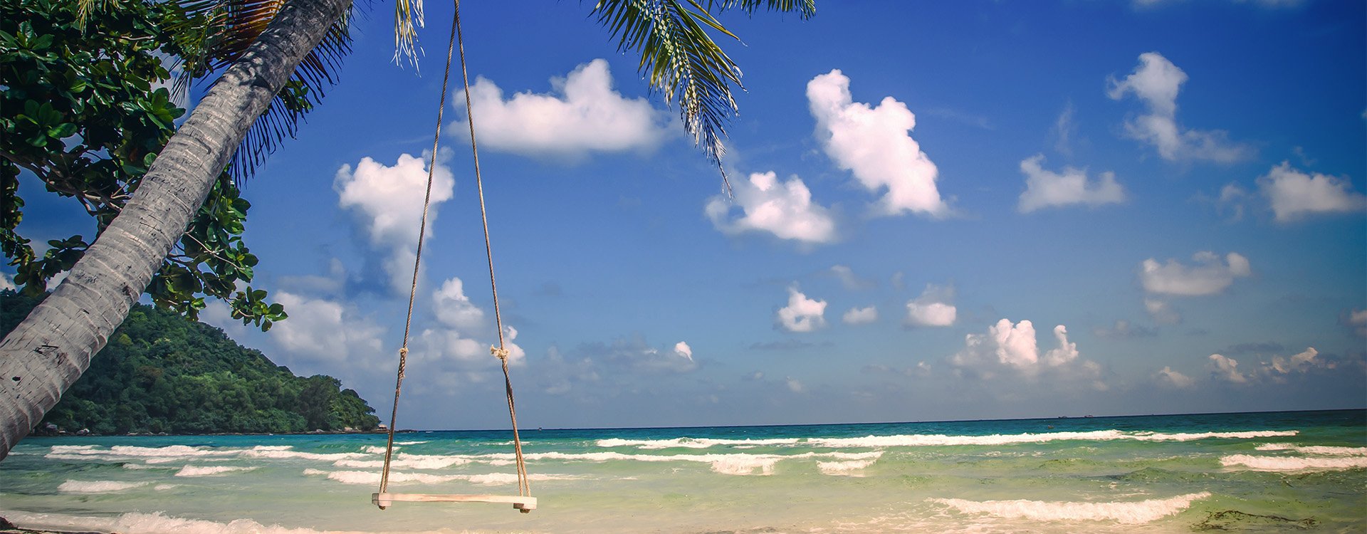 Phu Quoc island, Sao tropical beach in Vietnam. Palm trees and wooden swing on a clear sunny day