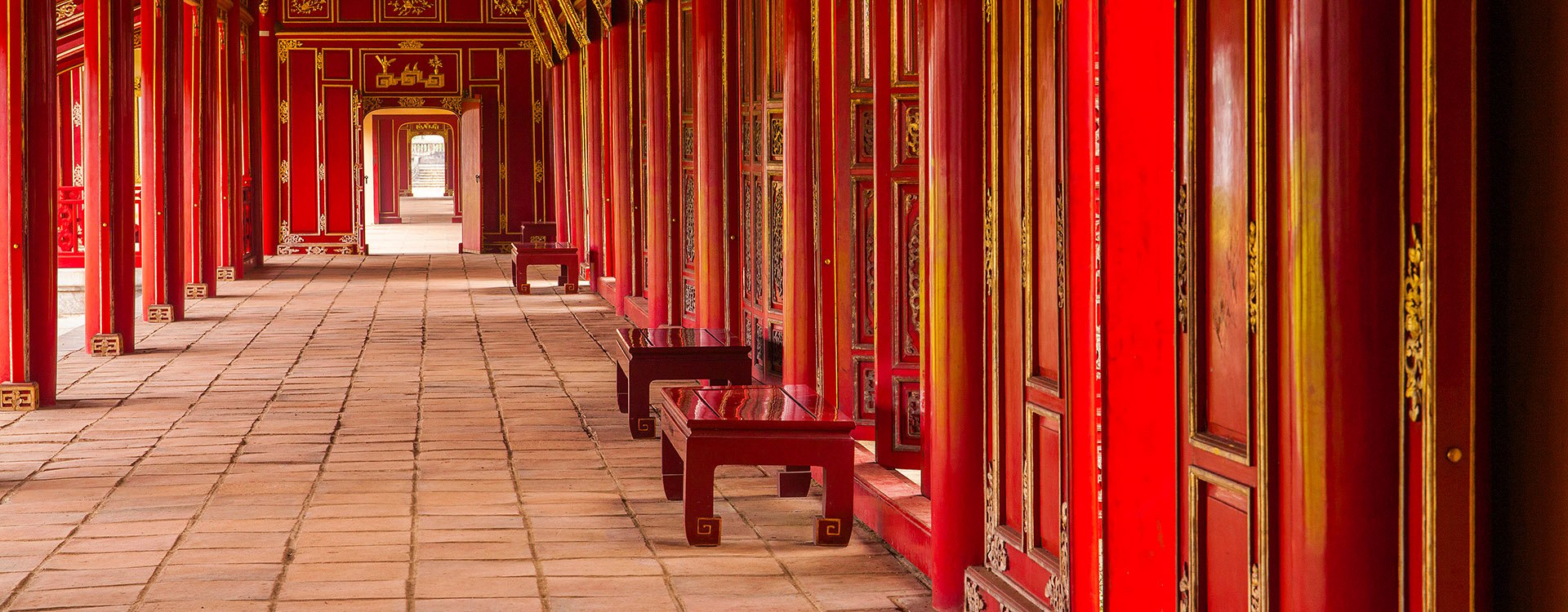 Red, wooden hallway of the Royal Palace, a UNESCO World Heritage site in Hue, Vietnam