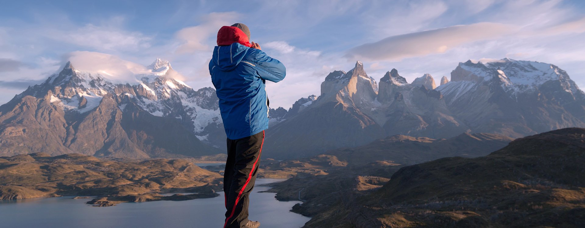 Man stood on rock photographing Los Cuernos Patagonia