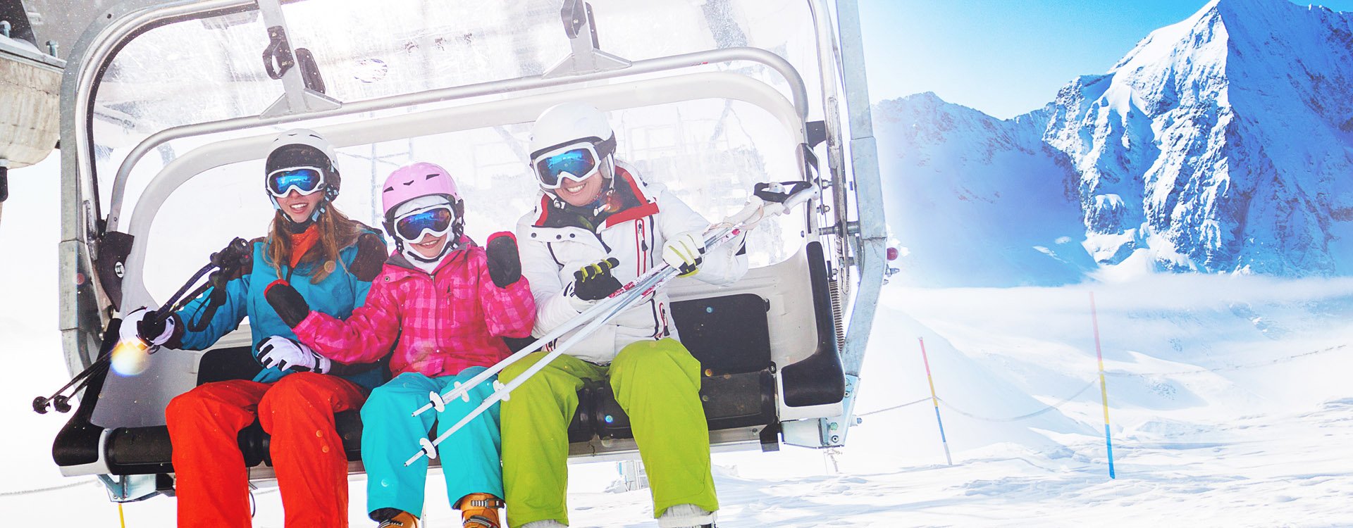 Winter - ski vacation - family on ski lift 
