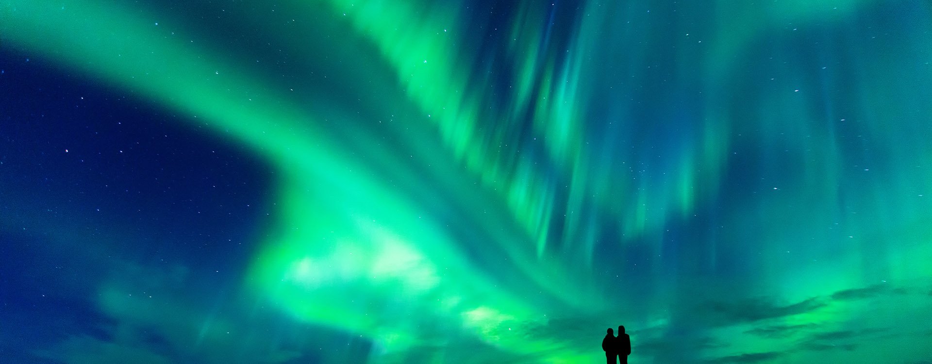 Couple watching Aurora Borealis in Finland