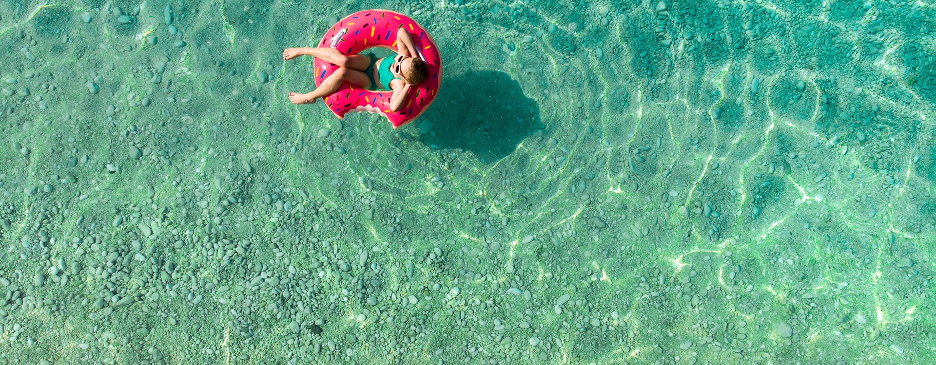 Young girl floating on toy ring Greece