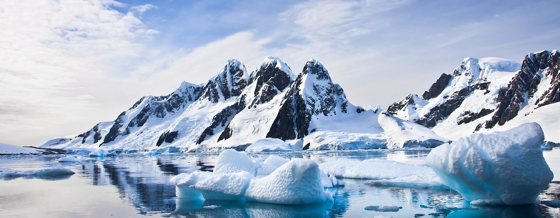 Beautiful snow-capped mountains against the blue sky in Antarctica