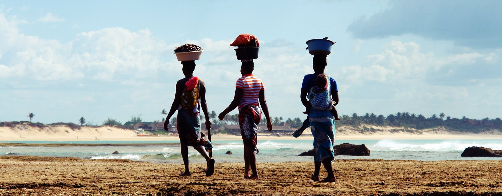 Mozambique women carrying basket  at Tofo beach, Mozambique