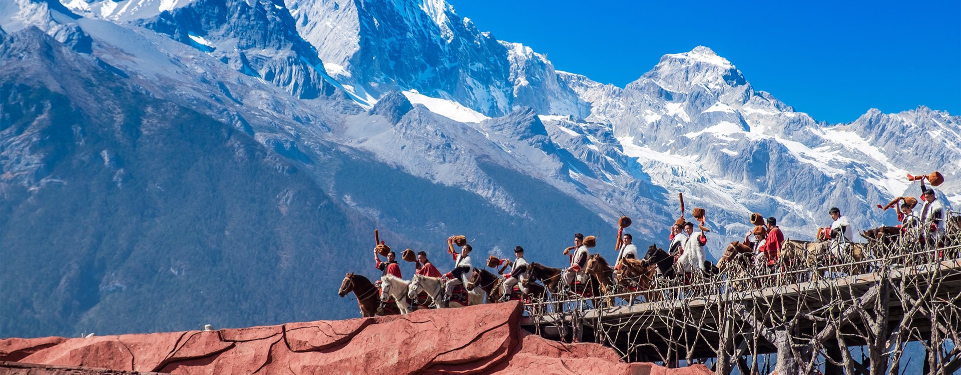 Traditional performance against Jade Dragon Snow Mountain. Lijiang, Yunnan, China