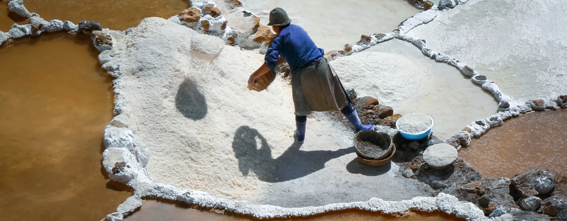Woman working on a salt terrace in Peru