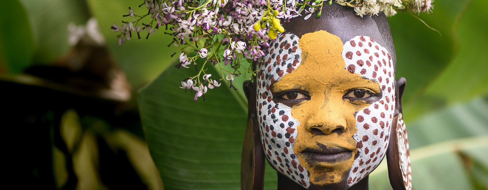 woman from Surmi tribe in Ethiopia, with flower decorations