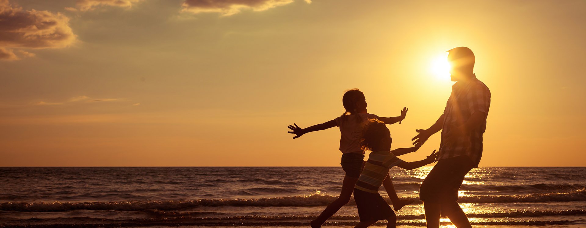 Father and children playing on the beach at the sunset time, brazilian beach. 