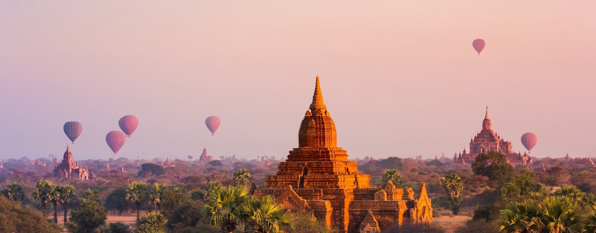 Ancient temple ruins at sunset Myanmar, hot air balloons